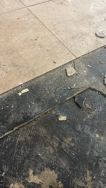 Black bitumen mastic floor removal in a SW8 flat